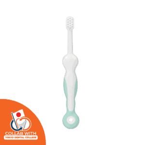 Green Combi Teteo Step 3 training toothbrush with firm bristles and an easy-grip handle, collab with tokyo dental collage icon appear in lower left corner of the image