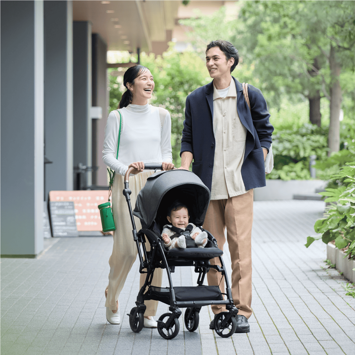 Combi Sugocal S stroller feature panel showing a couple walking with the stroller.